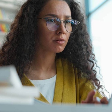 Diverse female adult learner on laptop