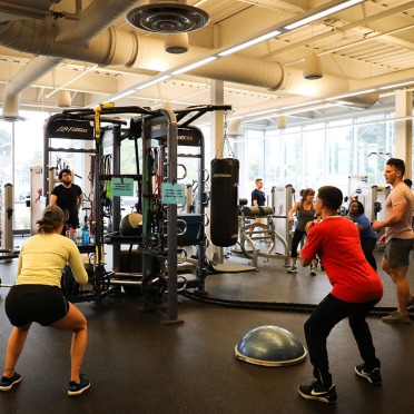 Students in a group workout on the fitness center floor