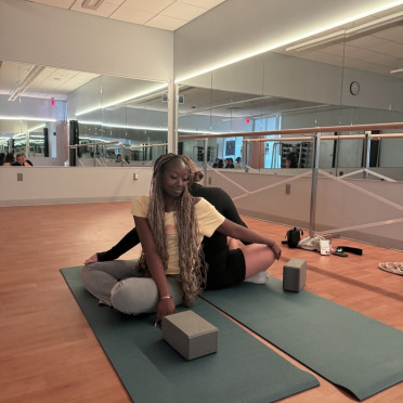 Students on yoga mats with blocks