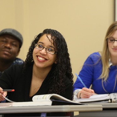 Students taking notes in a classroom