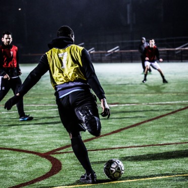 Three soccer players playing on the field