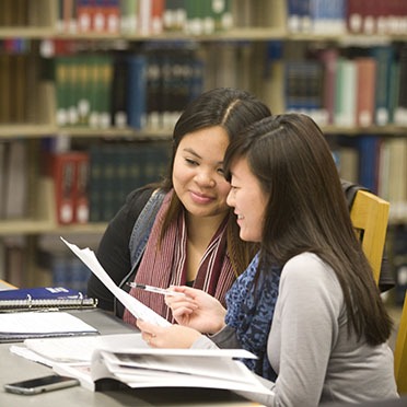 Two students study together in the library