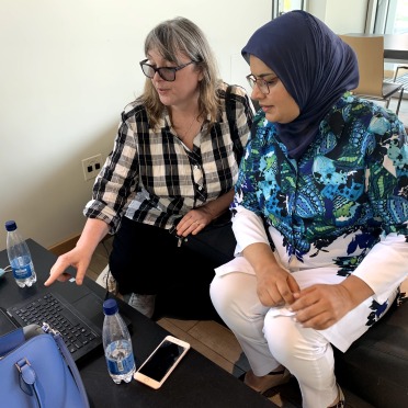 Two faculty members sitting together at a computer