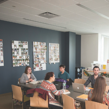 Students collaborate at a table in the Honors Center at Salem State.