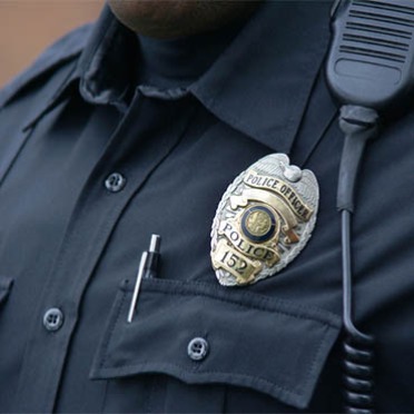 A police officer's badge displayed on his chest.