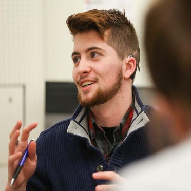 A male graduate student speaking in class