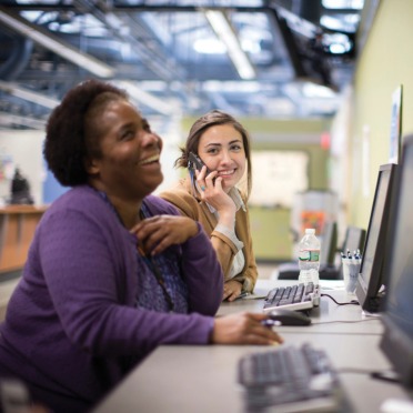 A student and staff member in the Student Navigation Center.