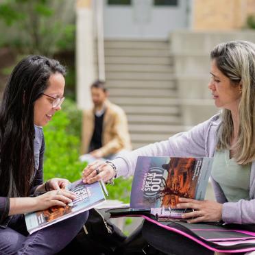 Two students talk outside at Salem State