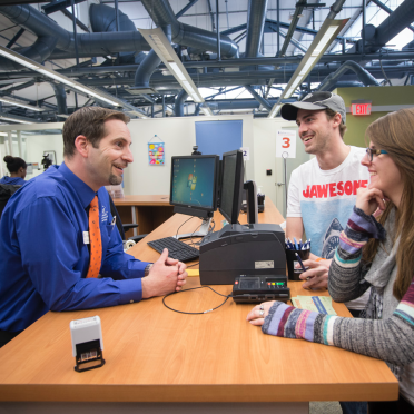 Student Navigation Center staff helping two students