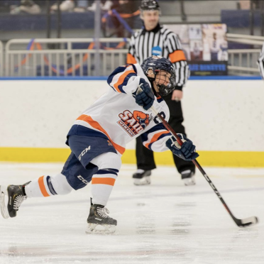 Hockey player skating on the rink