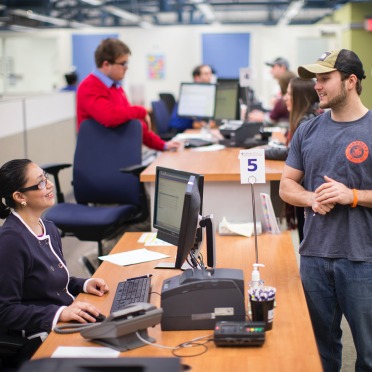 A Student Navigation Center staff member helping a student