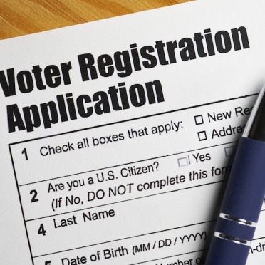 Close up of a voter registration form with a pen