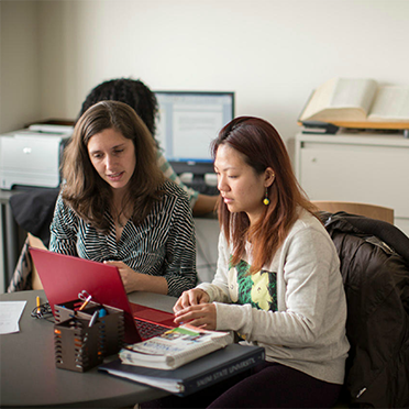 Two female students work together at the Writing Center