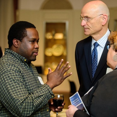 Two men and a woman talking in a circle