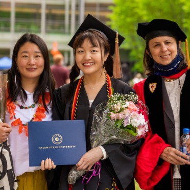 CIE staff with a new grad on campus