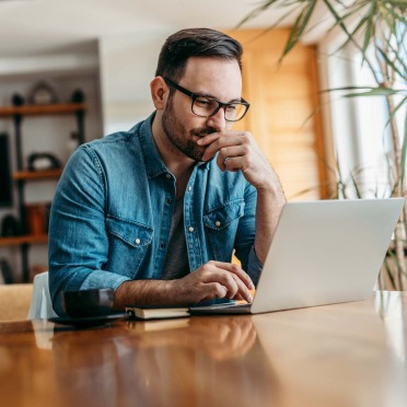 Man sitting at table on laptop