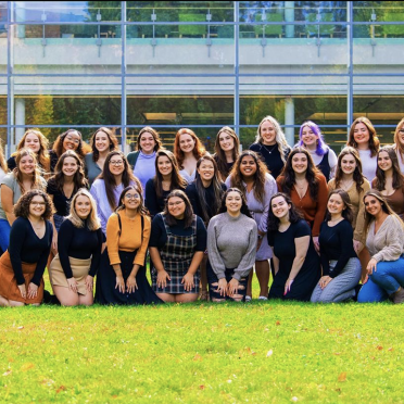 Members of theta phi alpha on the campus quad