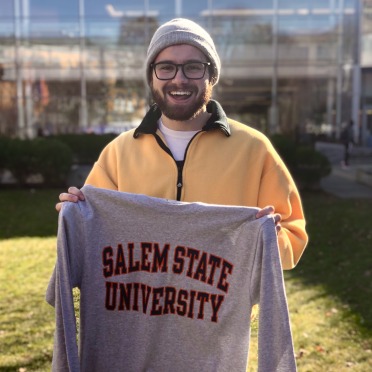 A student smiling with an SSU long sleeve tee