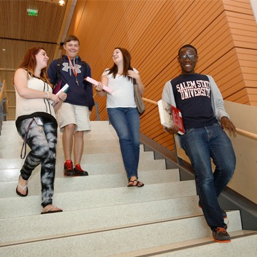 Students walking down the stairs in library