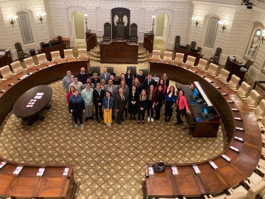 An Ariel view of Salem State students smiling inside of the Boston Capital.