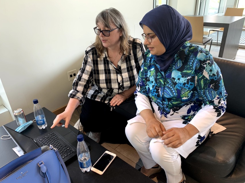 Two faculty members sitting together at a computer