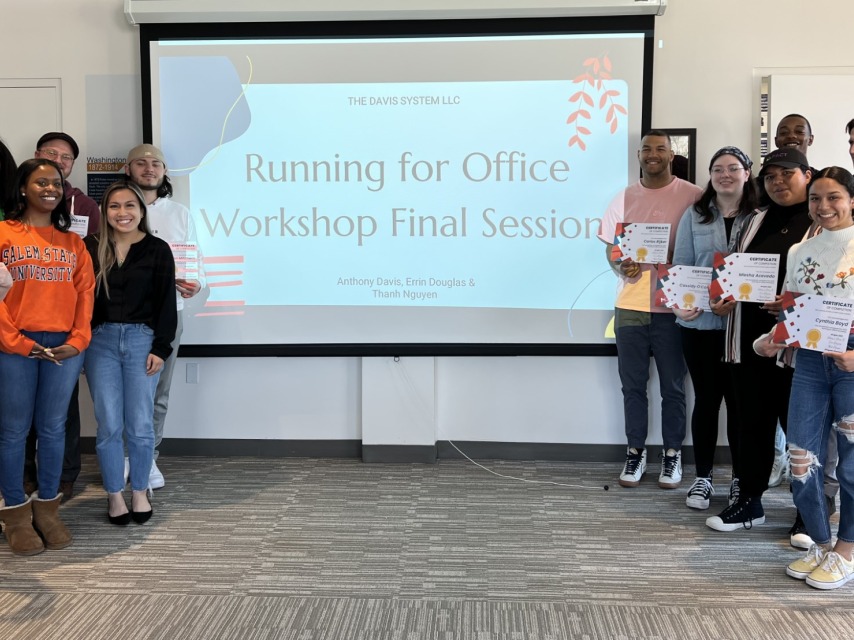 Students with smile and hold certificates around a projector that says "Running for Office Workshop Final Session"