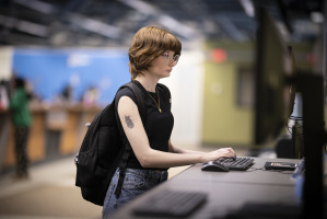 A student using a computer workstation at the Student Navigation Center at Salem State.