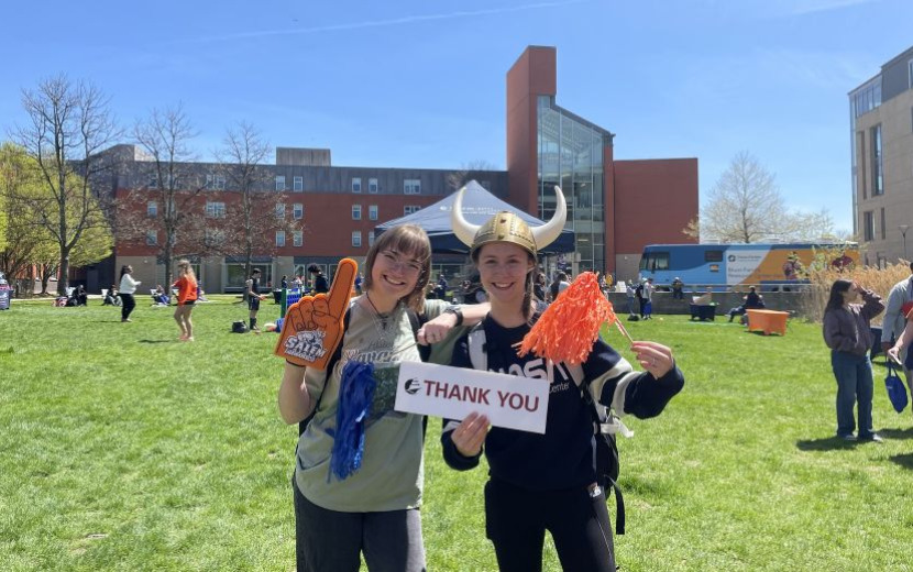VWD25 attendees celebrate our day of giving with signs