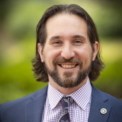 Mike Mitchell wearing blue jacket with shirt and tie