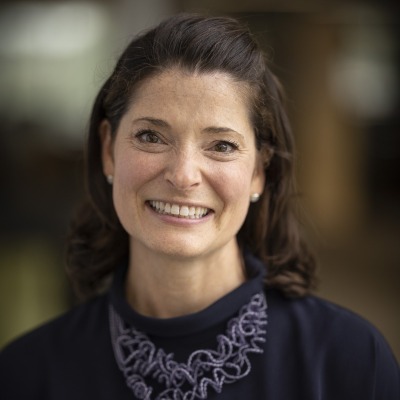 Anne Barker wearing purple shirt and necklace