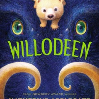 Cover of book Willodeen shows a small beigh bear with dragonfly wings perched between the eyes of a close up of a blue boar's head. The boar shows only eyes, nose, and curled tusks. The word WILLODEEN is in green font and centered on the cover. At the bottom of the image, just above the boar's nose, it says, "From Newbury Award winner Katherine Applegate.