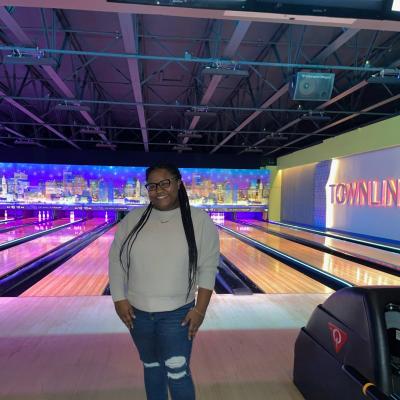 Janasia Ashford smiles at a bowling alley