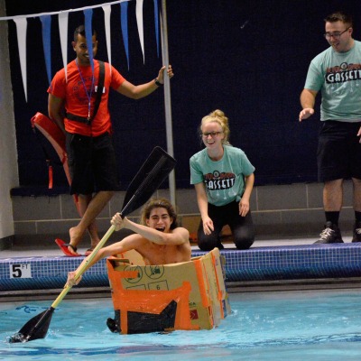 Students have a canoe race in the pool