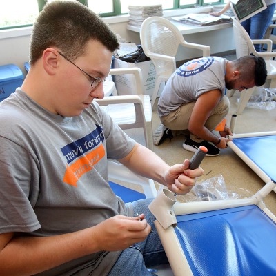 A first year student putting together dog beds at the animal shelter