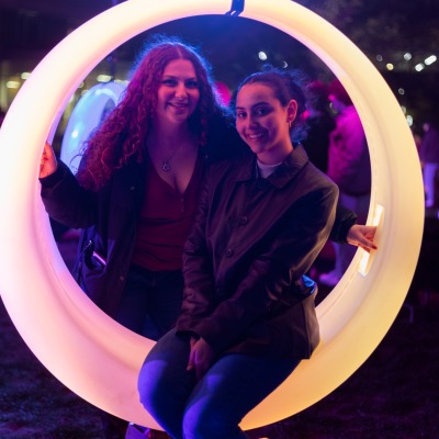 Students on Glow Swings