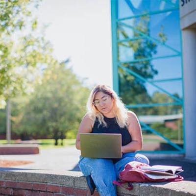 Girl outside on laptop