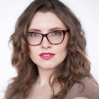 Headshot of Jenney Holland wearing glasses