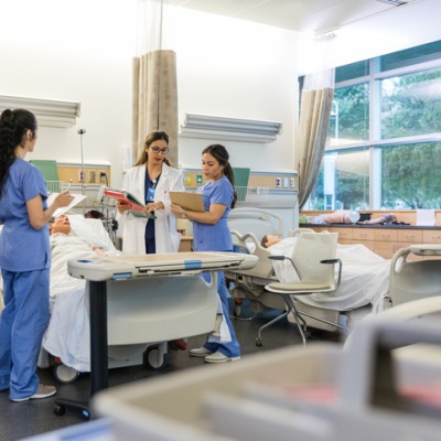 Students and faculty in a medical simulation lab