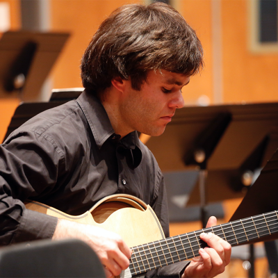 Musician playing guitar onstage