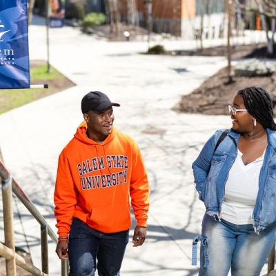 Two students chatting while they walk up stairs on North Campus