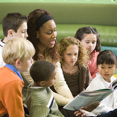 Teacher reading to a group of students