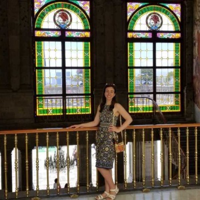 Irune Aparicio in front of stained glass windows