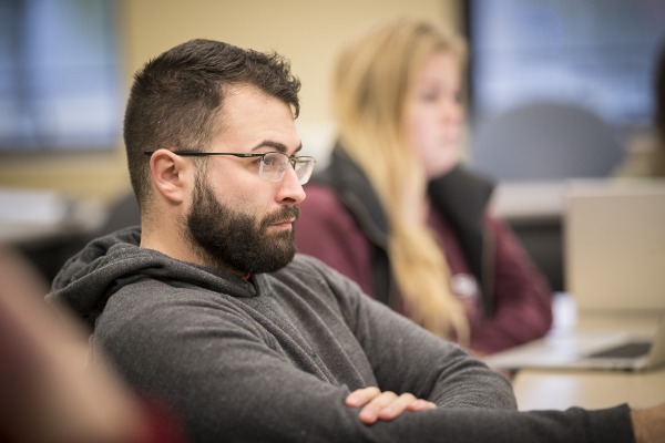 One student listening to a lecture in a classroom