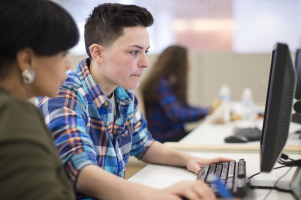 A student works with a counselor to register for classes.