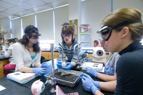 faculty with students in science lab