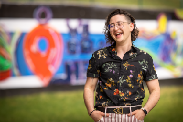 Evan Kravette standing in front of colorful wall