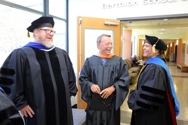 Three business faculty members laughing