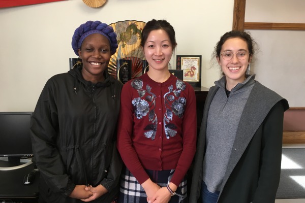 Three students who received scholarships stand together in the CIE