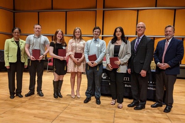 Student award recipients in a group with President Keenan and Bertolon School of Business leaders.