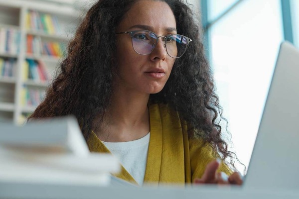 Diverse female adult learner on laptop